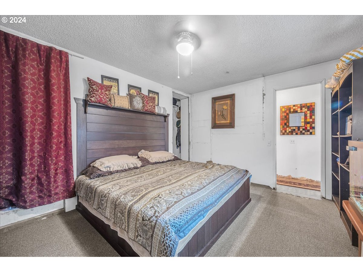 26901 Northwest St Helens Road Scappoose, OR 97056 - Photo 19 of 43 a bedroom with a bed and a bookshelf