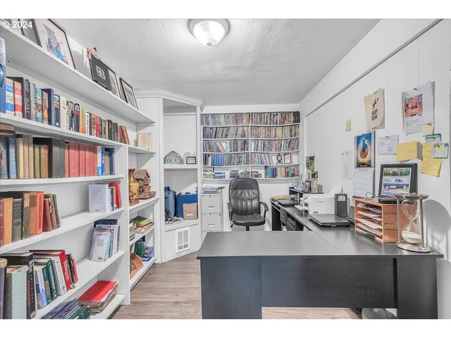 a work room with furniture and a book shelf