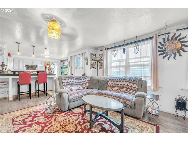 a living room with furniture and painting on the wall