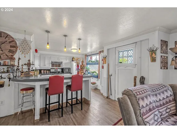 a kitchen with a sink a stove and cabinets