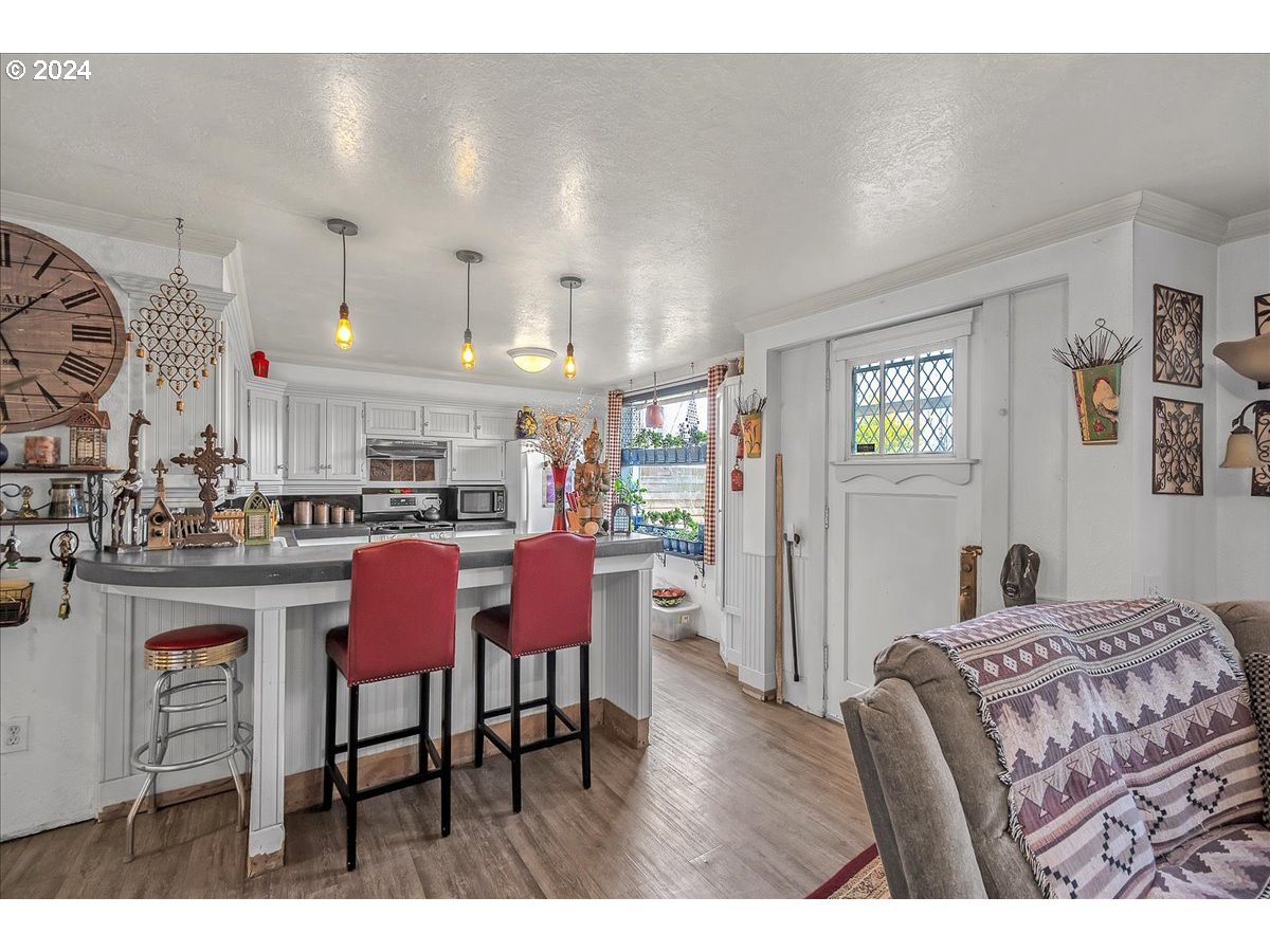26901 Northwest St Helens Road Scappoose, OR 97056 - Photo 30 of 43 a living room with furniture a dining table and kitchen view