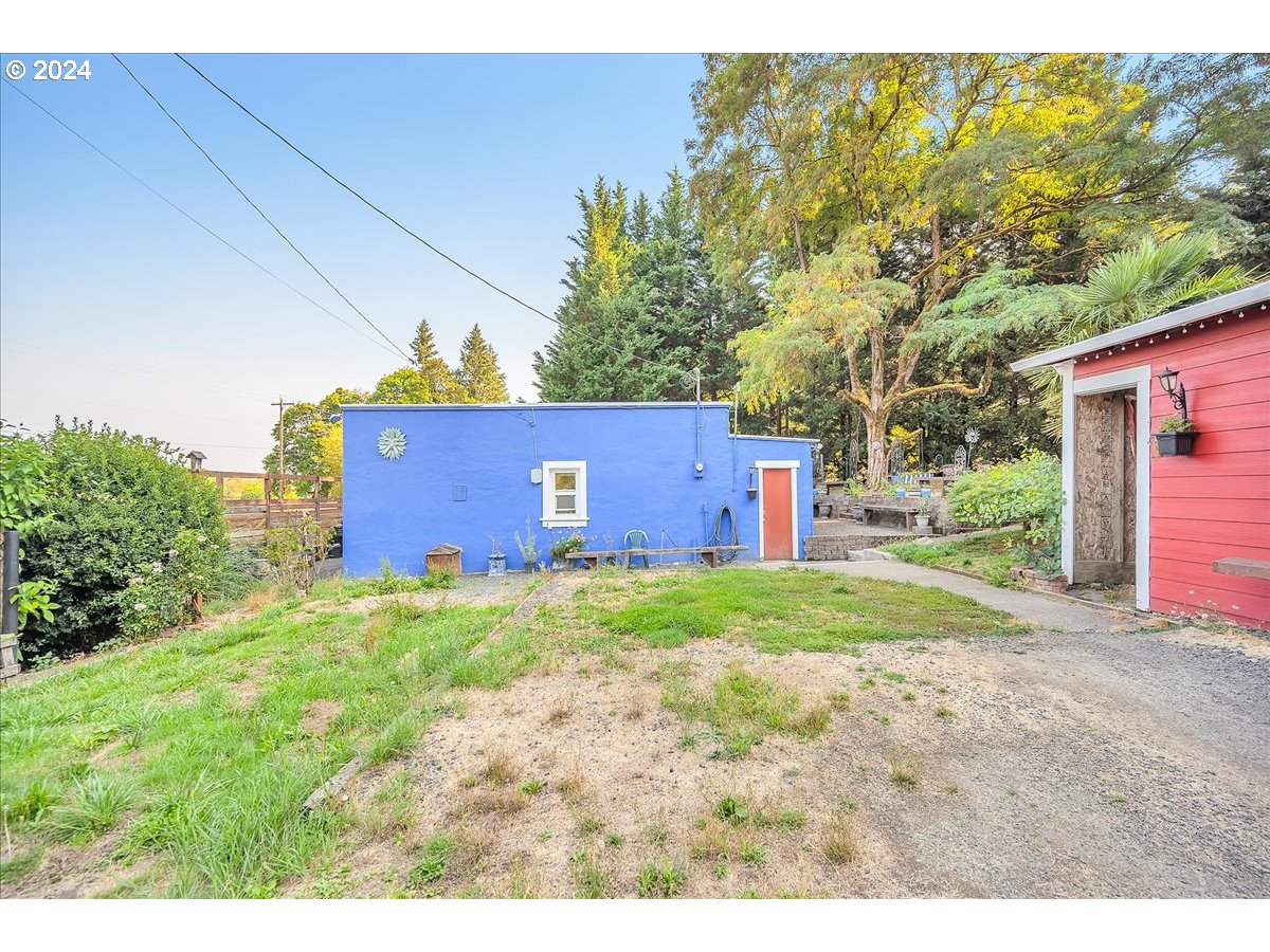 26901 Northwest St Helens Road Scappoose, OR 97056 - Photo 36 of 43 a backyard of a house with a garden and plants