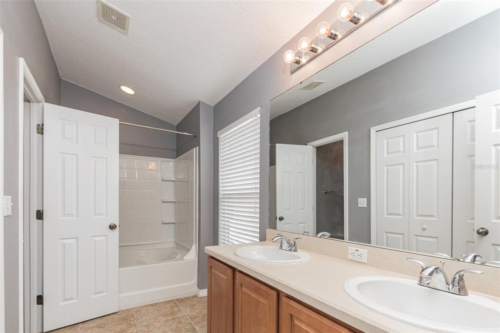 6723 Breezy Palm Drive Riverview, FL 33578 - Photo 11 of 16 a bathroom with a double vanity sink and a mirror