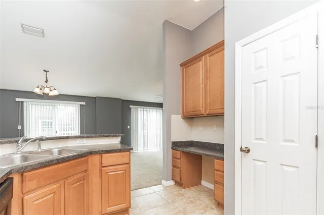 a bathroom with a granite countertop sink a toilet and a mirror