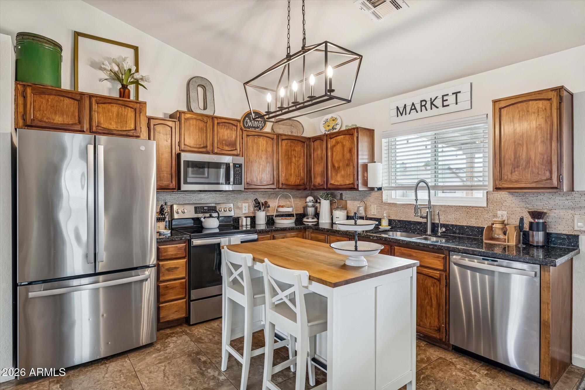 2019 East Butler Street Chandler, AZ 85225 - Photo 12 of 27 a kitchen with stainless steel appliances granite countertop a refrigerator a stove a sink a oven and a refrigerator