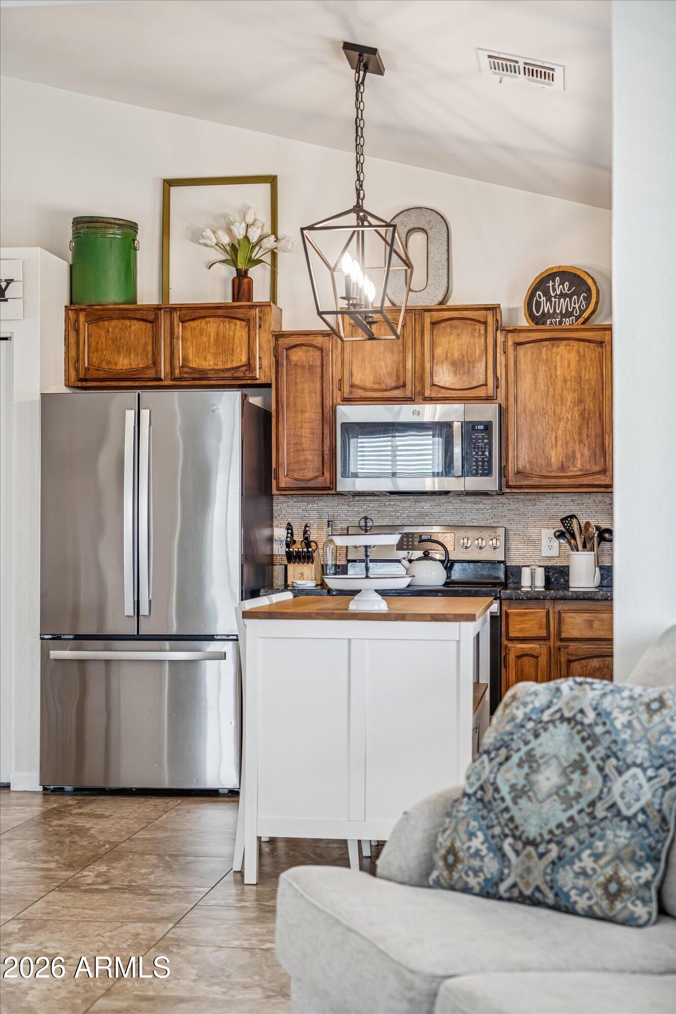 2019 East Butler Street Chandler, AZ 85225 - Photo 14 of 27 a kitchen with stainless steel appliances granite countertop a refrigerator a stove and a sink with wooden floor