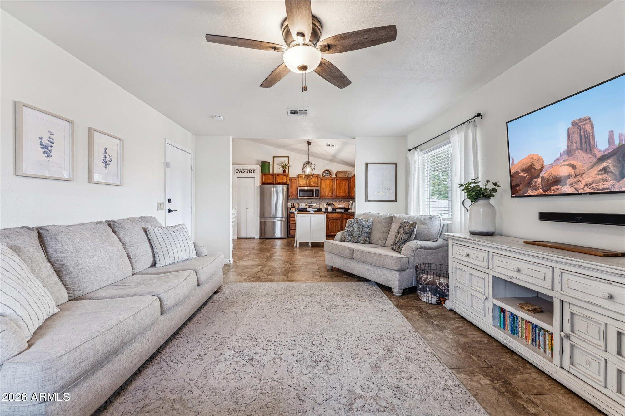 2019 East Butler Street Chandler, AZ 85225 - Photo 19 of 27 a living room with furniture and a flat screen tv