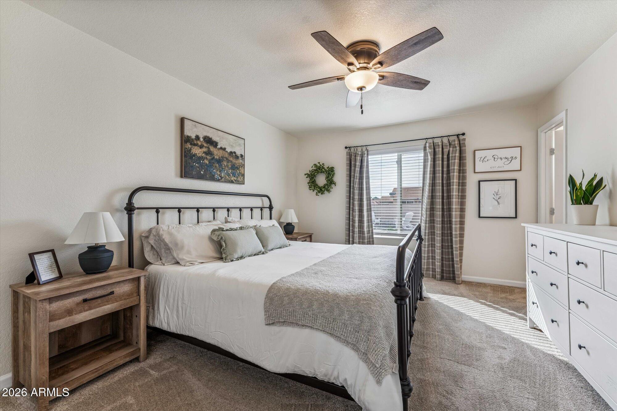 2019 East Butler Street Chandler, AZ 85225 - Photo 20 of 27 a bedroom with a large bed and a chandelier