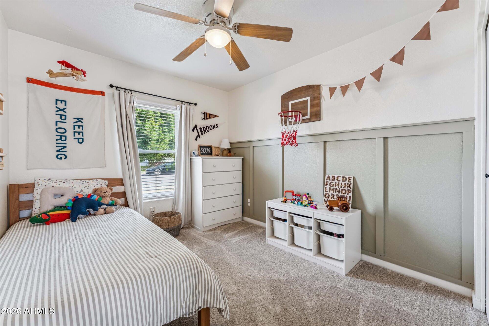 2019 East Butler Street Chandler, AZ 85225 - Photo 23 of 27 a bedroom with a bed and a chandelier