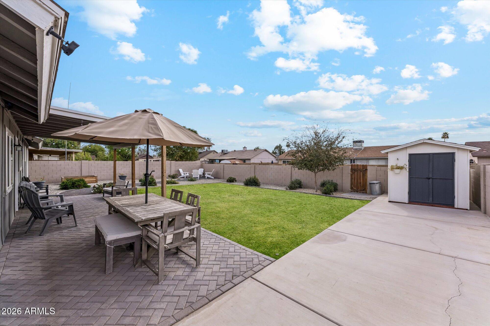 2019 East Butler Street Chandler, AZ 85225 - Photo 26 of 27 a view of a patio with a table and chairs under an umbrella