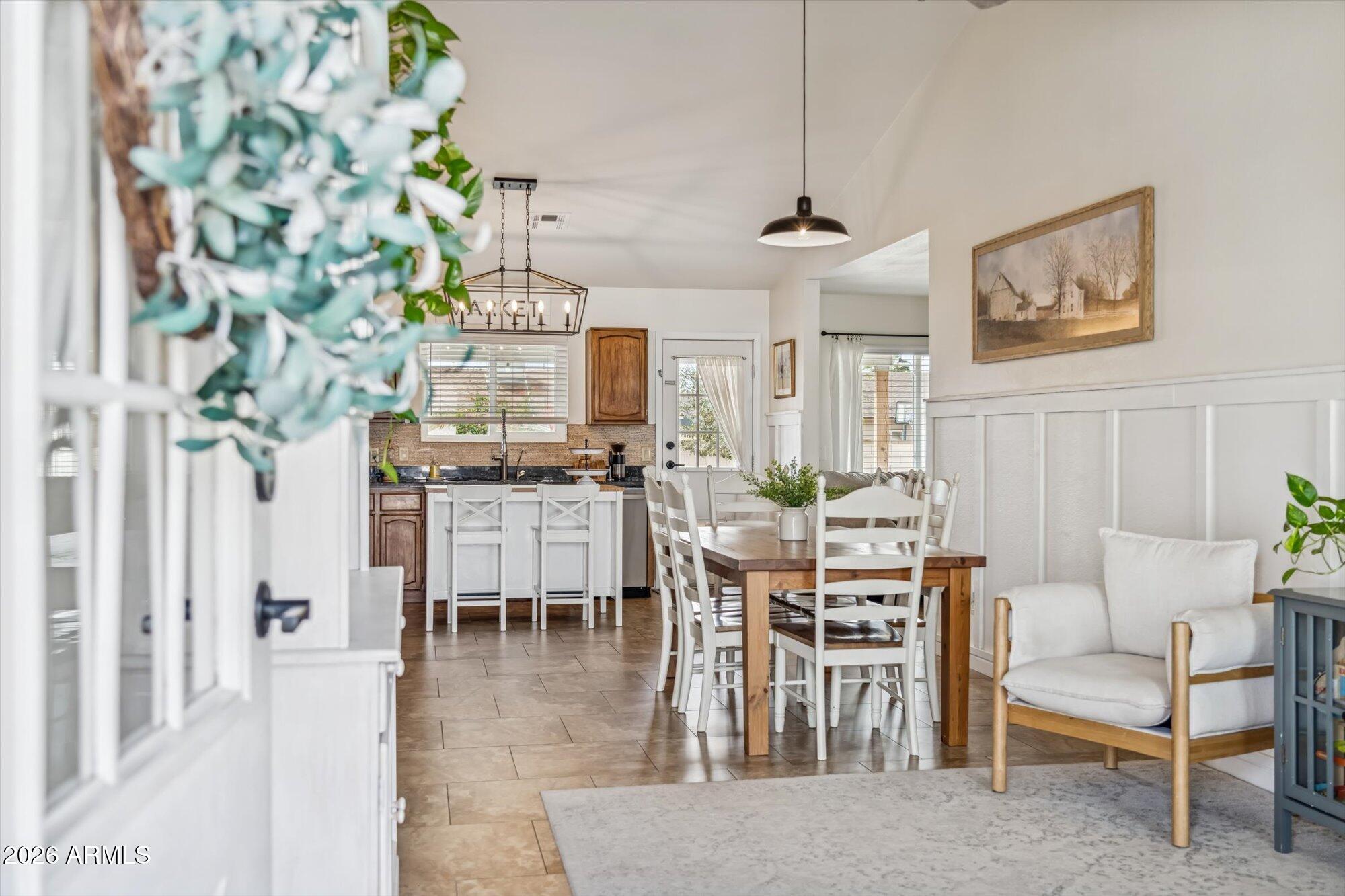 2019 East Butler Street Chandler, AZ 85225 - Photo 2 of 27 a dining room with furniture a rug and a chandelier