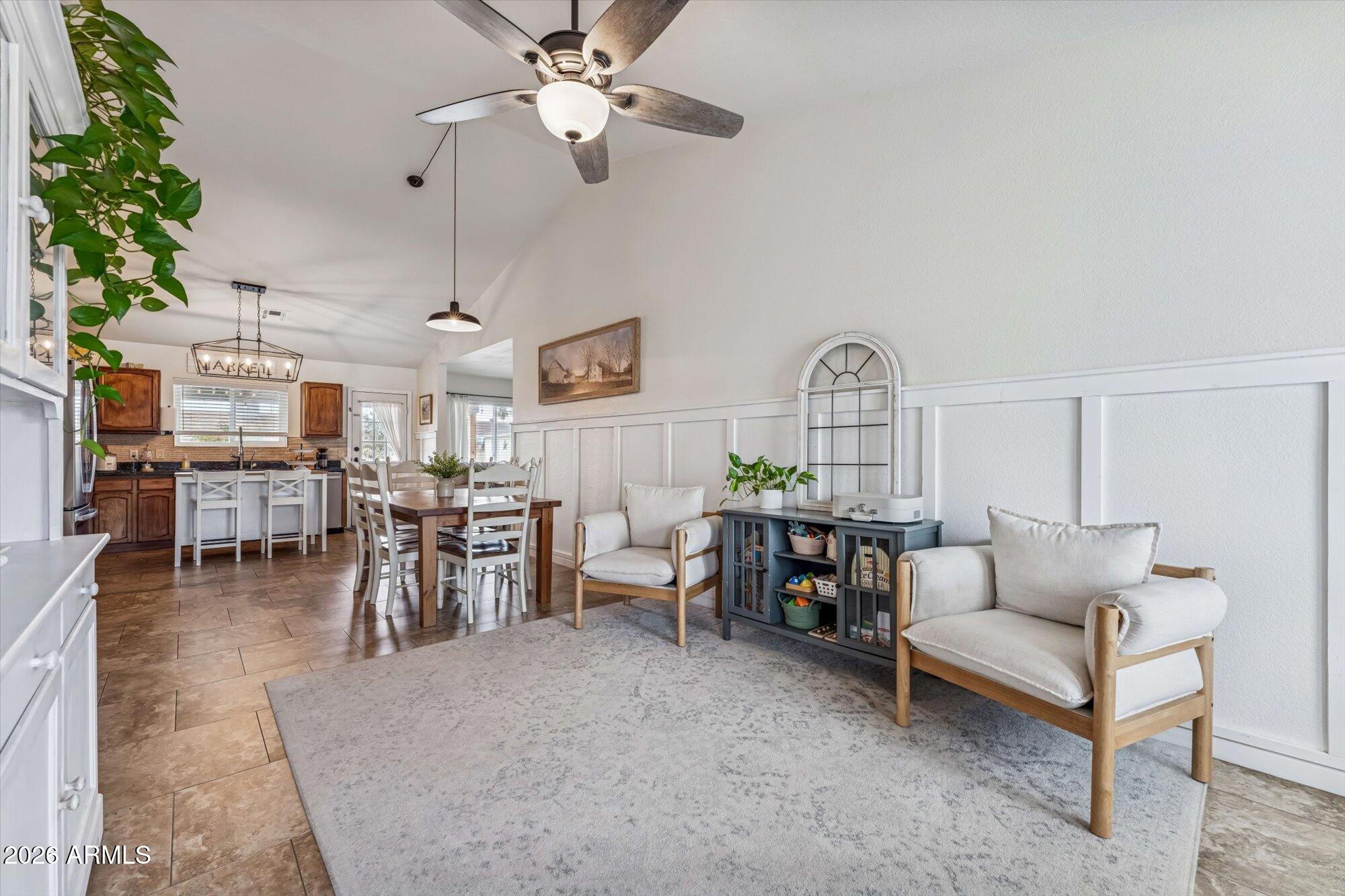 2019 East Butler Street Chandler, AZ 85225 - Photo 8 of 27 a living room with lots of furniture a chandelier and a painting on the wall