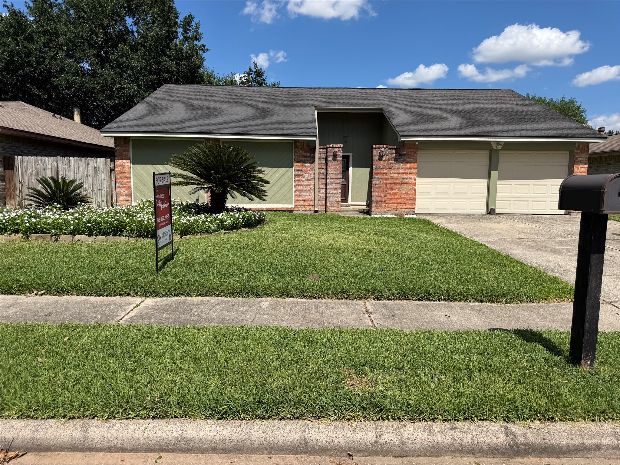 21514 Slippery Creek Lane Spring, TX 77388 - Photo 2 of 27 a front view of a house with a yard and a garage