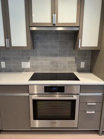 a stove top oven sitting inside of a kitchen