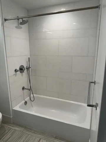 a bathroom with a shower and a glass door