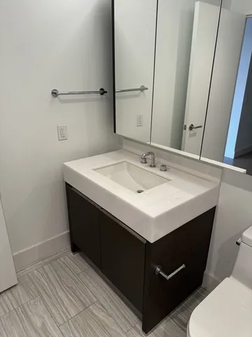 a bathroom with a sink vanity and toilet