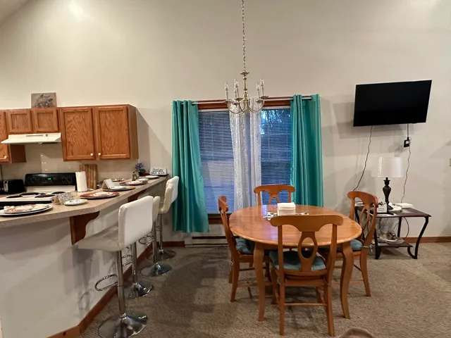 a view of a dining room with furniture and a flat screen tv