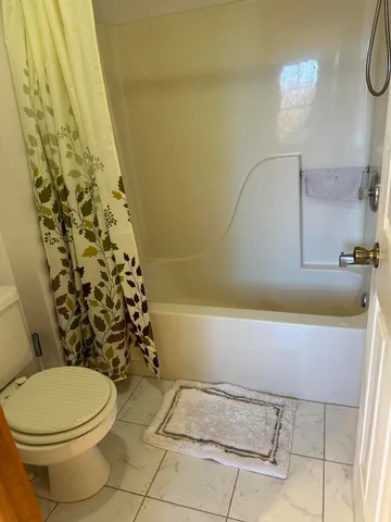 a bathroom with a toilet and shower