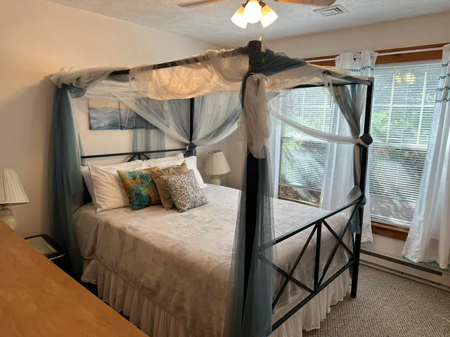 a bedroom with a bed and a glass top table