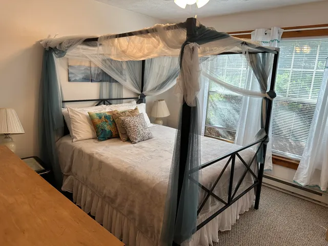 a bedroom with a bed and a mirror