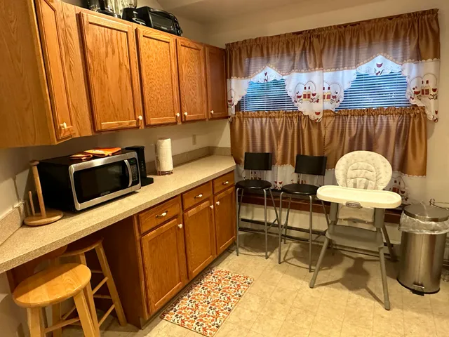 a kitchen with a sink cabinets and window