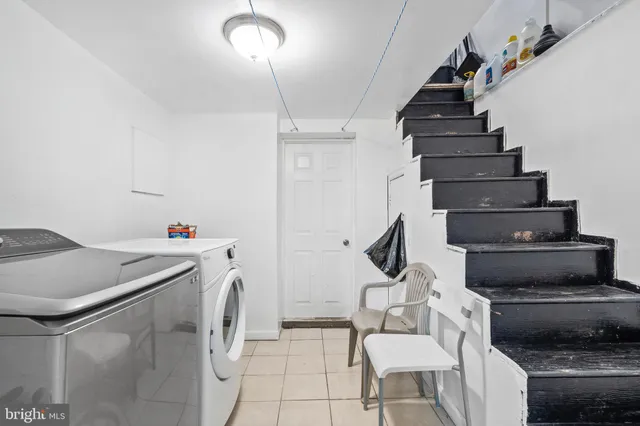 a utility room with dryer washer and storage