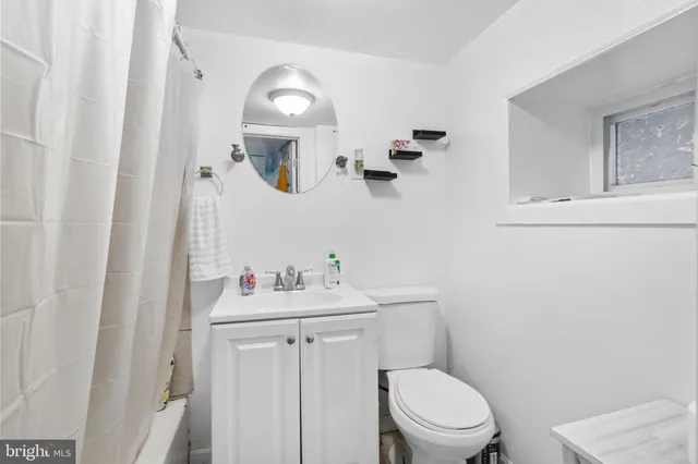 a bathroom with a sink a toilet and mirror