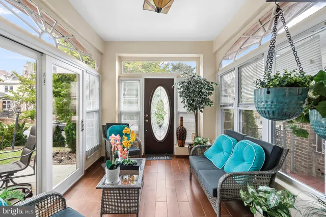 a living room filled with furniture and a large window