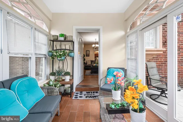 a living room with furniture and flowers