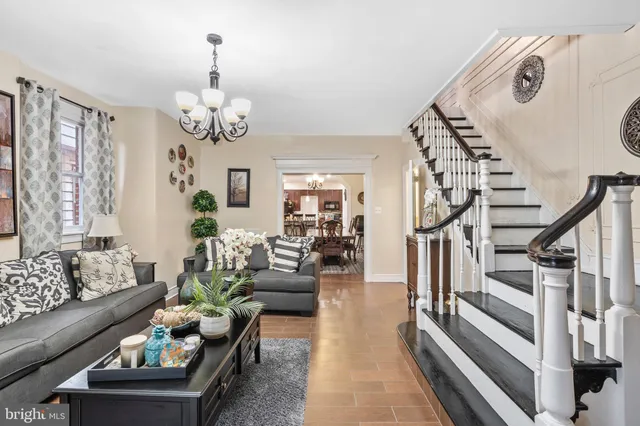 a living room with furniture chandelier and a chandelier