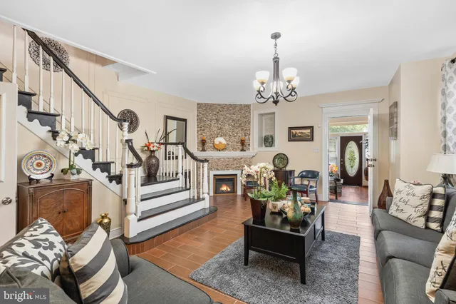 a living room with furniture and a chandelier