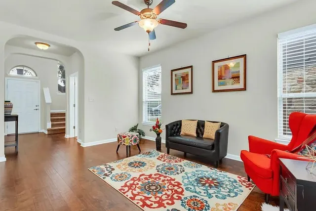 a living room with furniture and a wooden floor