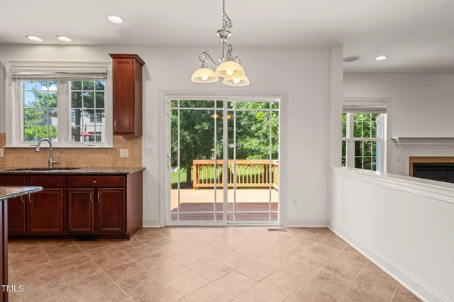 a open kitchen with granite countertop a stove and a sink with granite countertops