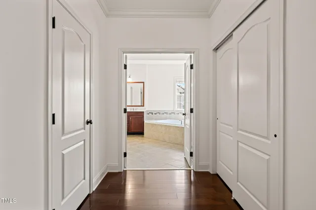 a view of a hallway with wooden floor