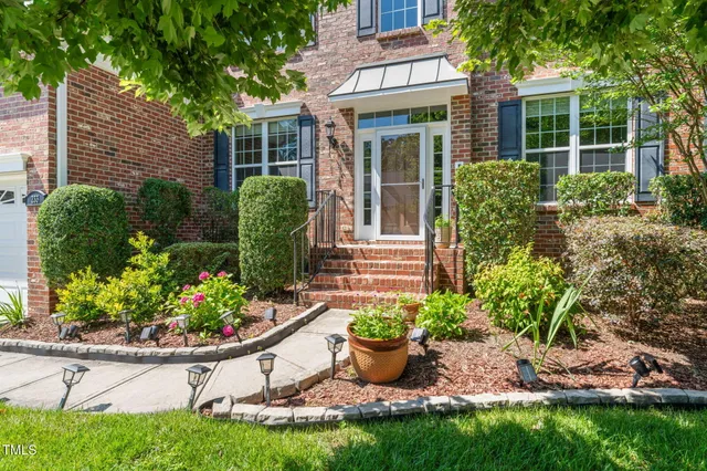 a view of a backyard with potted plants and a fountain