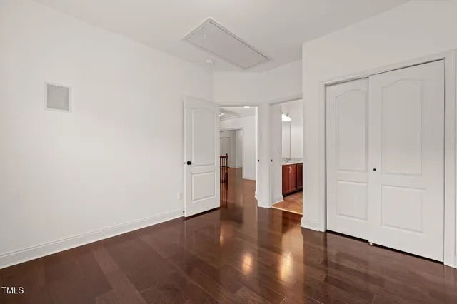 a view of a big room with wooden floor and windows