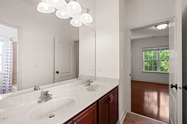 a bathroom with a sink vanity and a mirror