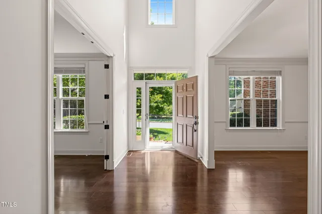 a view of an entryway with wooden floor and garden