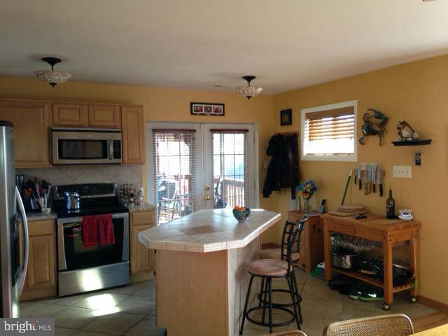 2140 Ballenger Creek Pike Point of Rocks, MD 21777 - Photo 5 of 23 a kitchen with a stove a sink and a microwave