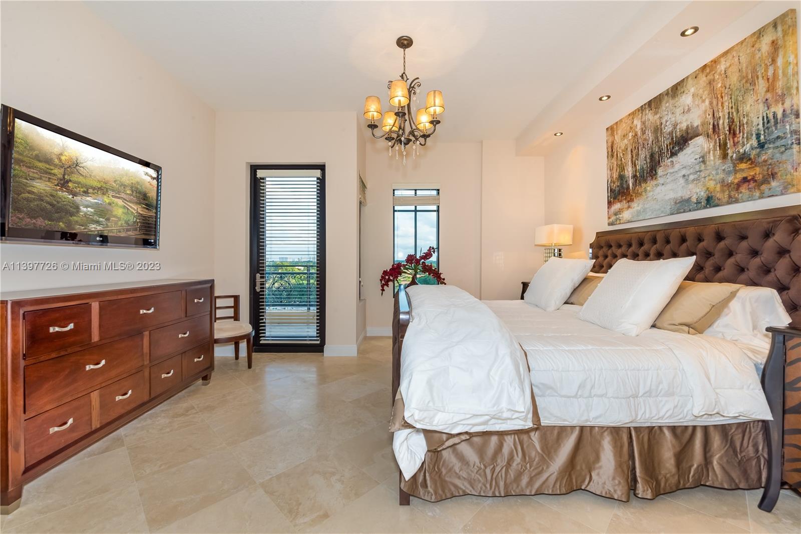 200 East Palmetto Park Road, Unit 700 Boca Raton, FL 33432 - Photo 22 of 31 a bedroom with a bed and a flat screen tv