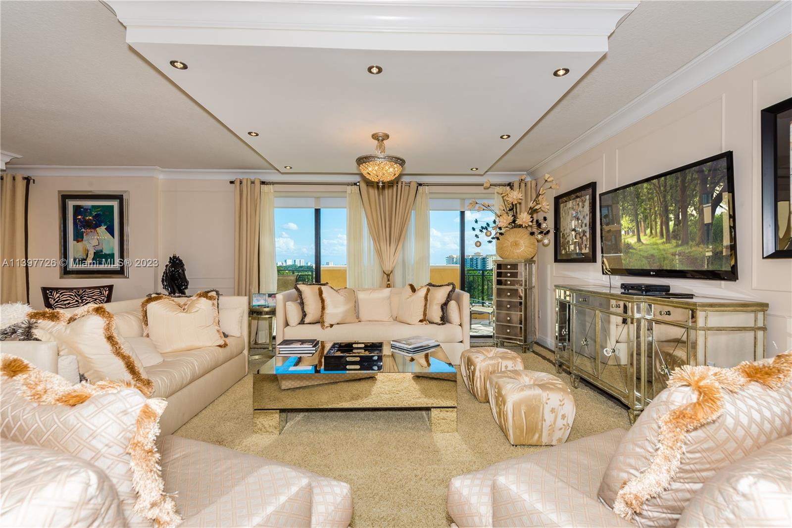 200 East Palmetto Park Road, Unit 700 Boca Raton, FL 33432 - Photo 4 of 31 a living room with furniture and a flat screen tv