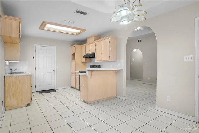 a view of kitchen with granite countertop cabinets and a sink