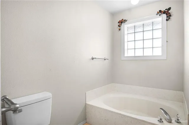 a white bath tub sitting next to a shower