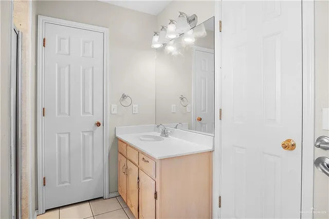 a bathroom with a sink vanity and a mirror