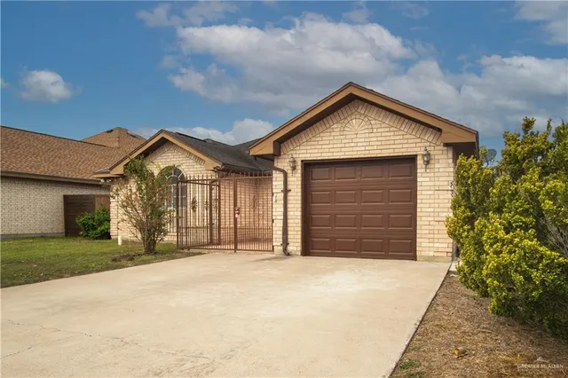 a view of a house with a yard and garage