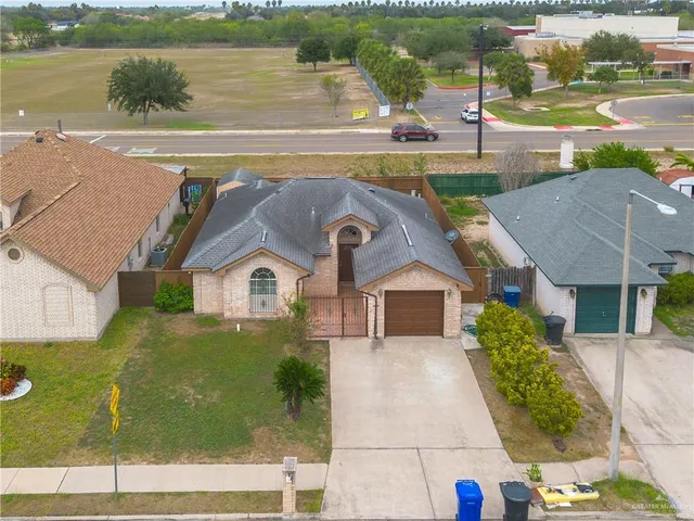 an aerial view of a tennis ground and a big yard