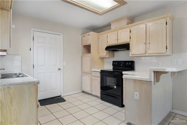 a kitchen with cabinets and appliances