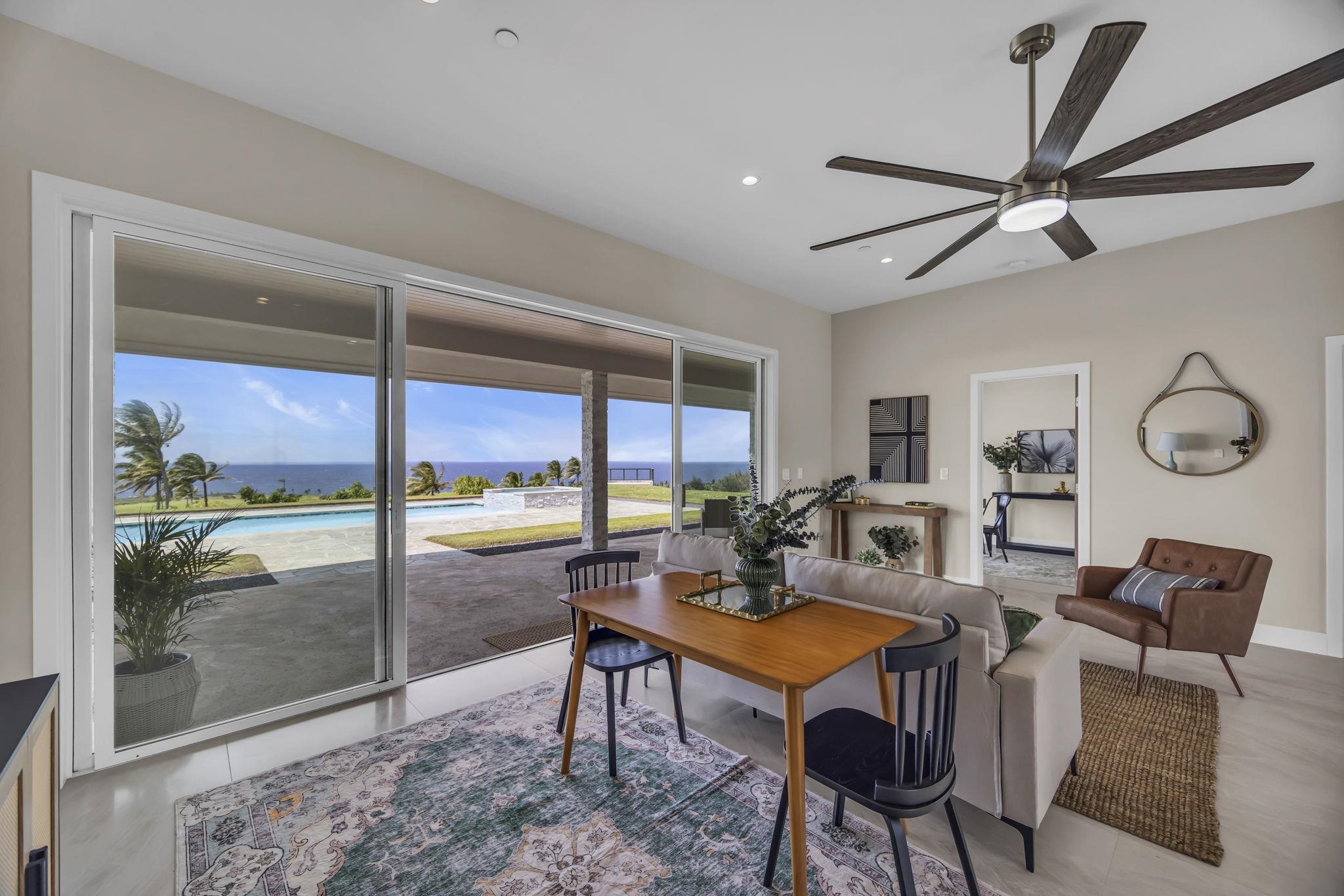500 Kai Huki Circle, Unit B Haiku, HI 96708 - Photo 11 of 50 a living room with furniture a rug and a floor to ceiling window