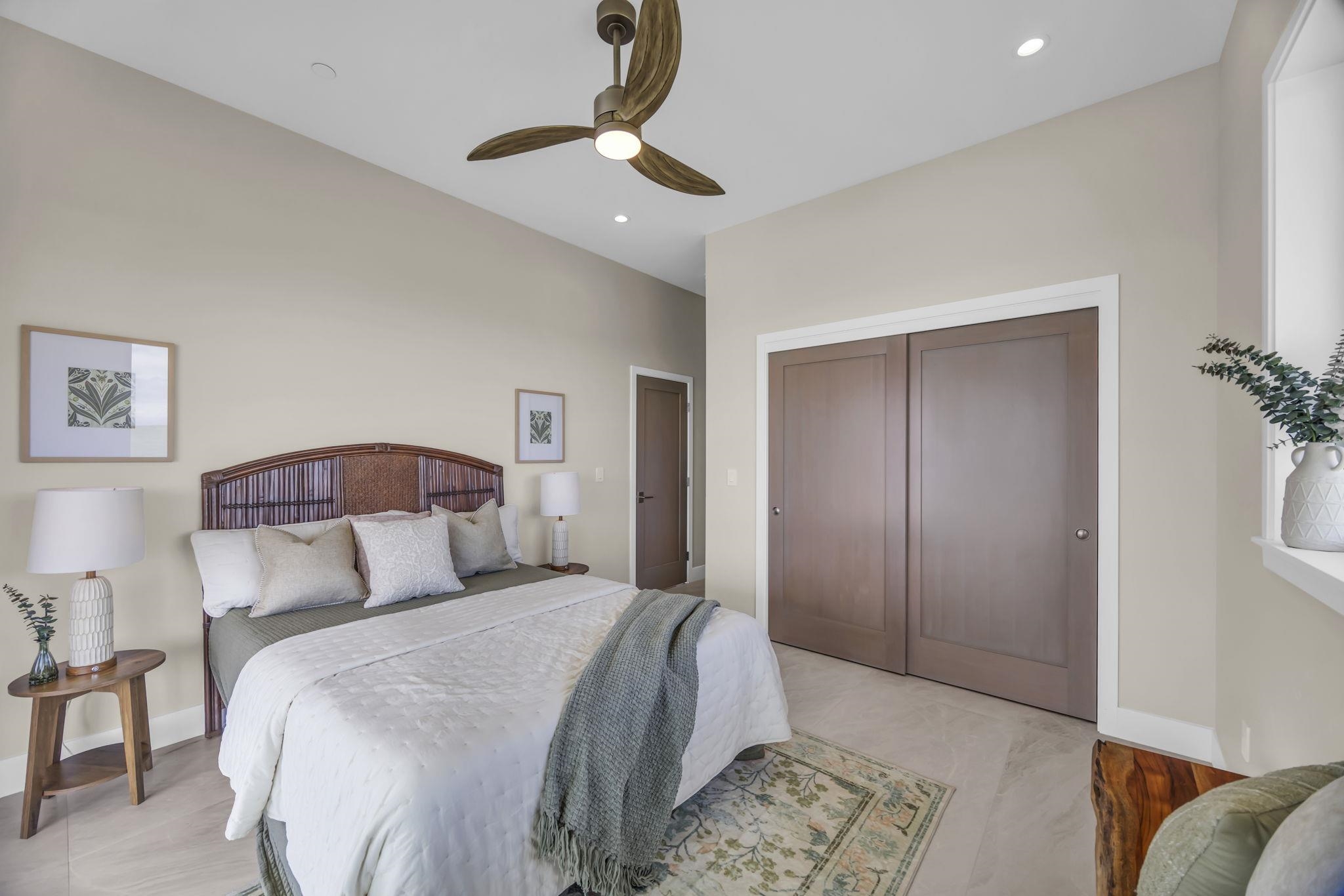 500 Kai Huki Circle, Unit B Haiku, HI 96708 - Photo 18 of 50 a bedroom with a large bed and a chandelier