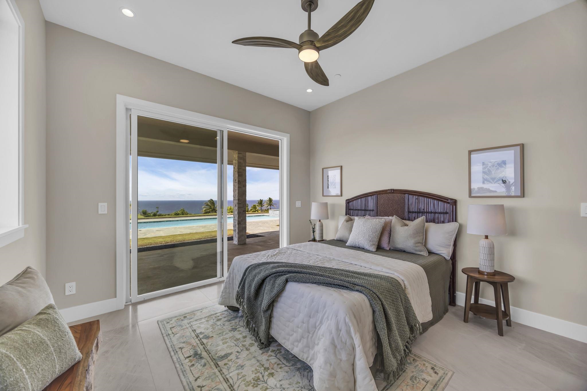 500 Kai Huki Circle, Unit B Haiku, HI 96708 - Photo 19 of 50 a bedroom with a bed and a chandelier